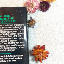 Load image into Gallery viewer, a book on a table with flowers on it
