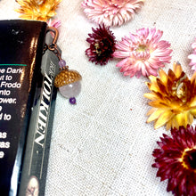 Load image into Gallery viewer, a book laying on top of a table next to flowers
