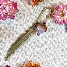 Load image into Gallery viewer, a close up of a pair of earrings with flowers in the background
