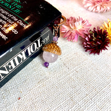 Load image into Gallery viewer, a pair of earrings sitting on top of a book
